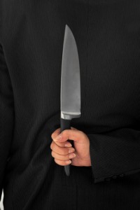 Closeup Businessman Holding Knife Behind His Back conceptual
