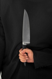 Closeup Businessman Holding Knife Behind His Back conceptual